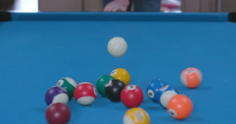 Man Breaking Racked Pool Balls in Eight-Ball Formation on Blue Billiards Table Stock Footage 88226907