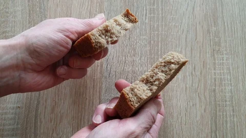 Man breaks black rye bread bread Stock Footage 105922780