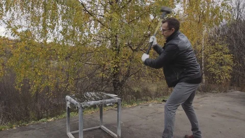 Man breaks the car window. Slowmotion Stock Footage 97387016