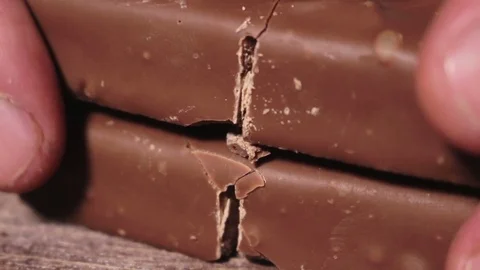 Man Breaks A Chocolate Bar Stock Footage 70565894