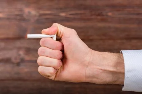 Man breaks a cigarette in his hand. Quitting smoking. Concept. Stock Photos