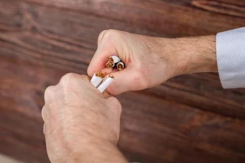 Man breaks cigarettes in his hands. Quit smoking. Concept. Stock Photos