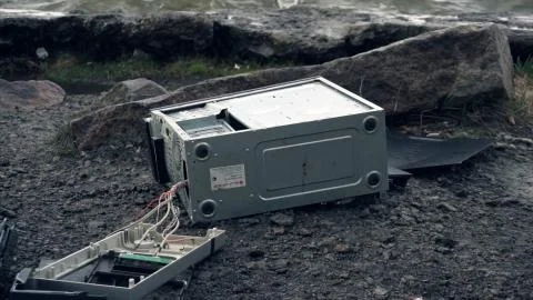 Man breaks a computer with a sledgehammer. A man destroys a computer on the Stock Photos
