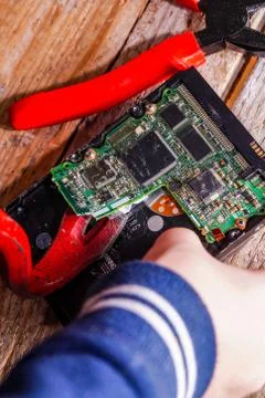 A man breaks a computer using locksmith tools. Stock Photos