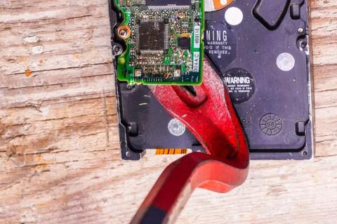 A man breaks a computer using locksmith tools. Stock Photos