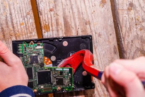 A man breaks a computer using locksmith tools. Stock Photos