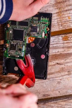 A man breaks a computer using locksmith tools. Stock Photos