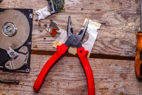 A man breaks a computer using locksmith tools. Stock Photos