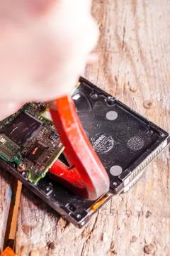 A man breaks a computer using locksmith tools. Stock Photos