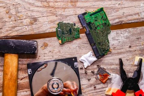 A man breaks a computer using locksmith tools. Stock Photos