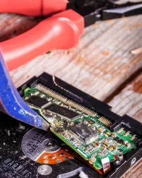A man breaks a computer using locksmith tools. Stock Photos
