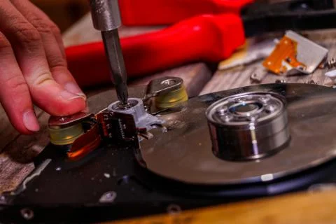 A man breaks a computer using locksmith tools. Stock Photos