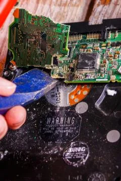 A man breaks a computer using locksmith tools. Stock Photos