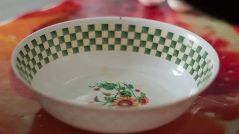The man breaks the egg in a plastic bowl Stock Footage 73561646