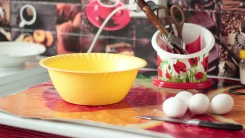 The man breaks the egg in a plastic bowl Stock Footage 73561752