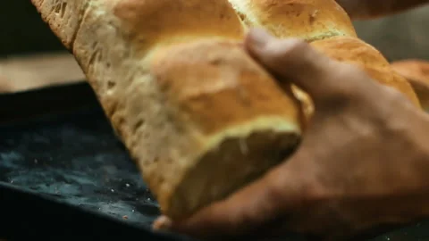 Man breaks hands hot fresh bread Stock Footage 99602504