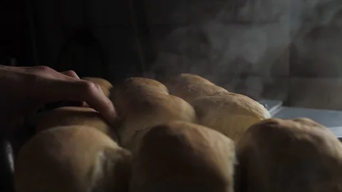 Man breaks hands hot fresh bread Stock Footage 124690764