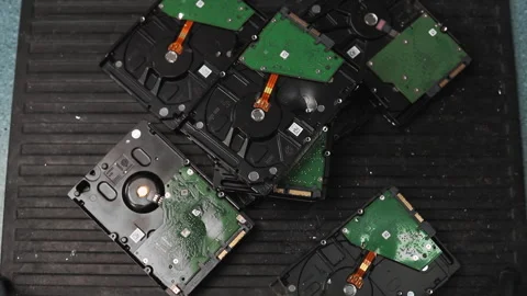 Man breaks old hard disk drives with hammer in workshop Stock Footage 197104853
