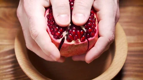 Man breaks pomegranate. Stock Footage 83629415