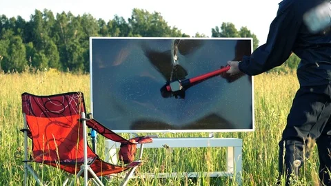 Man breaks the TV with a sledgehammer in slow motion Stock Footage 112852462