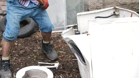 Man breaks a washing machine with a big hammer, home appliances Stock Footage 111913000