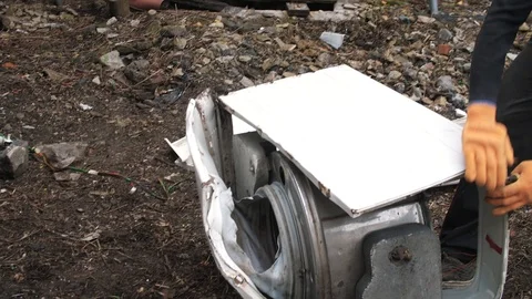Man breaks a washing machine with a big hammer, home appliances Stock Footage 111913046