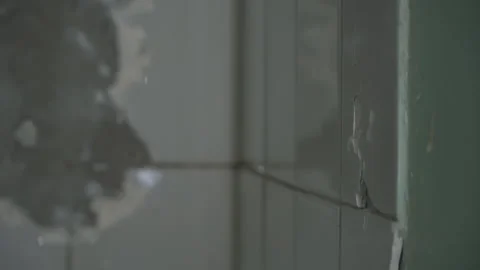 Man breaks white tiles with a hammer 스톡 동영상 160597637