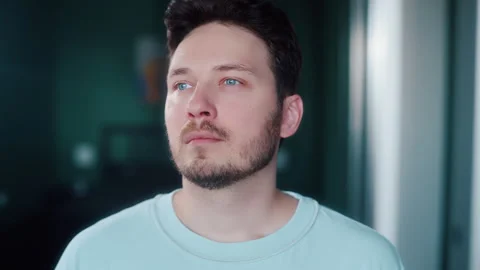 Man breathing deeply and closing eyes by window Video stock 319442401
