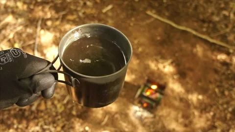 Man Brewing Coffee over Campfire. Coffee by the Campfire Stock Footage 306533217