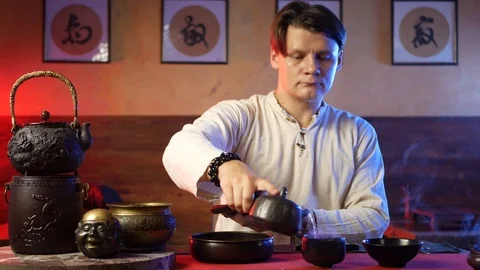 A man brews PU-erh tea according to traditional Chinese customs Stock Footage 114319606