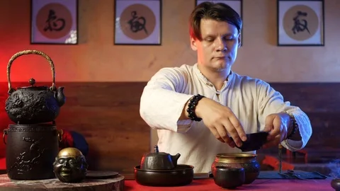 A man brews PU-erh tea according to traditional Chinese customs Stock Footage 114319615