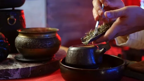 A man brews PU-erh tea according to traditional Chinese customs Stock Footage 114319635