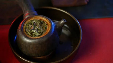 A man brews PU-erh tea according to traditional Chinese customs Stock Footage 114319667