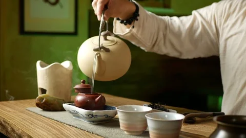 A man brews PU-erh tea according to traditional Chinese customs Stock Footage 114418176
