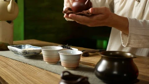 A man brews PU-erh tea according to traditional Chinese customs Stock Footage 114418190