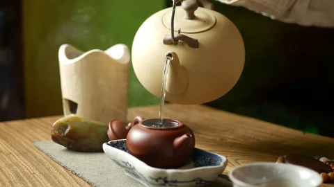 A man brews PU-erh tea according to traditional Chinese customs Stock Footage 114418208