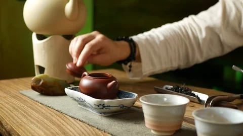 A man brews PU-erh tea according to traditional Chinese customs Stock Footage 114418245
