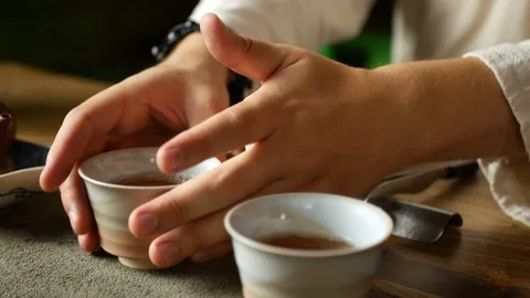 A man brews PU-erh tea according to traditional Chinese customs Stock Footage 114418250