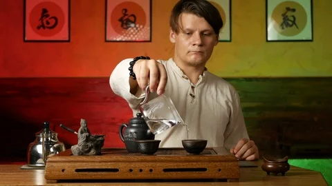 A man brews PU-erh tea according to traditional Chinese customs Stock Footage 114602043