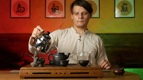A man brews PU-erh tea according to traditional Chinese customs Stock Footage 114602053