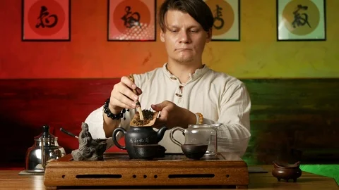 A man brews PU-erh tea according to traditional Chinese customs Stock Footage 114602074