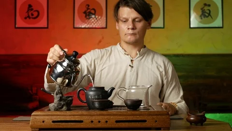A man brews PU-erh tea according to traditional Chinese customs Stock Footage 114602092