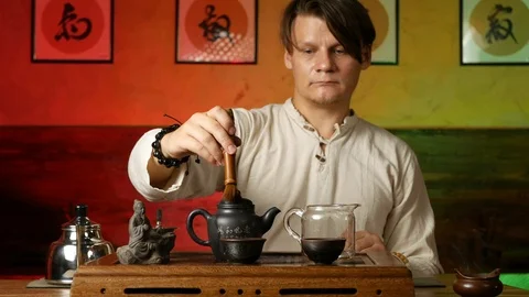A man brews PU-erh tea according to traditional Chinese customs Stock Footage 114602117