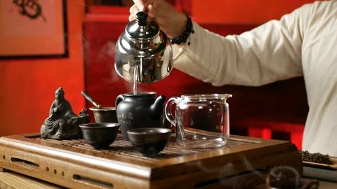 A man brews PU-erh tea according to traditional Chinese customs Stock Footage 114602124