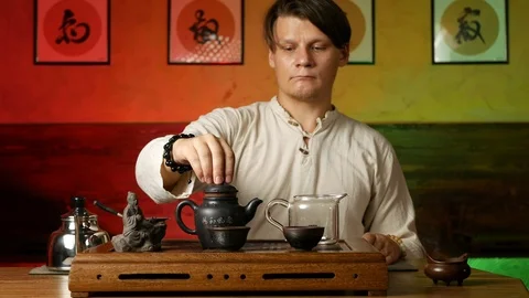A man brews PU-erh tea according to traditional Chinese customs Stock Footage 114602203