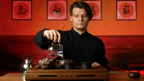 A man brews PU-erh tea according to traditional Chinese customs Stock Footage 114818186