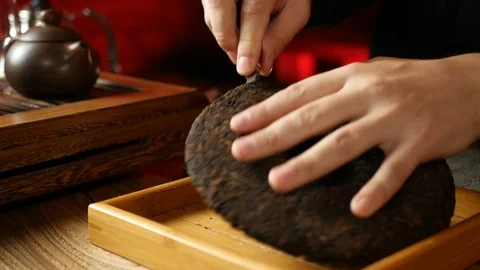 A man brews PU-erh tea according to traditional Chinese customs Stock Footage 114818348