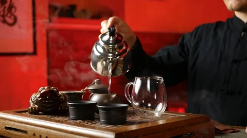 A man brews PU-erh tea according to traditional Chinese customs Stock Footage 114818377