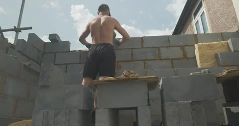 Man bricklaying on a building site close-up Stock Footage 246380288