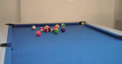 Man bridging cue on pool table at home, chalking, breaking balls to start game, Stock Footage 341467466